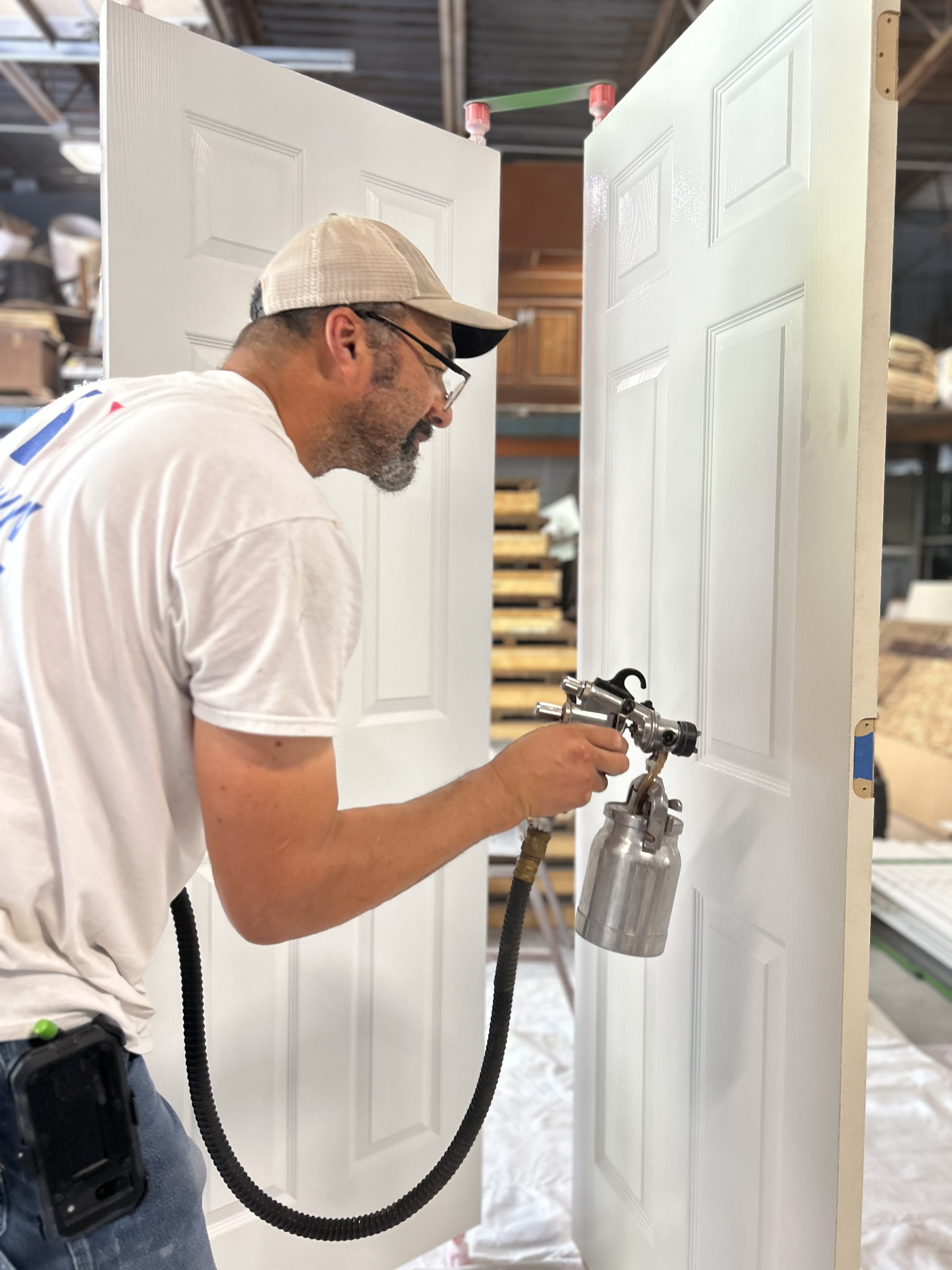 Spraying white finish on interior doors
